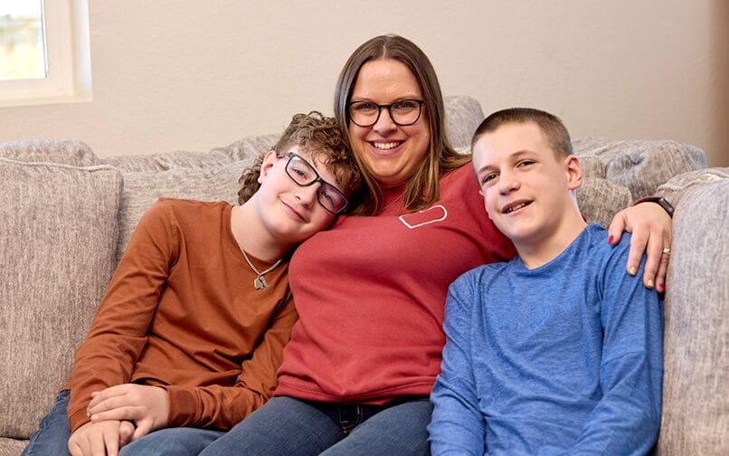 mom with kids hugging them