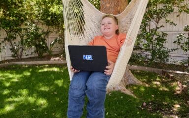 boy with computer at the park