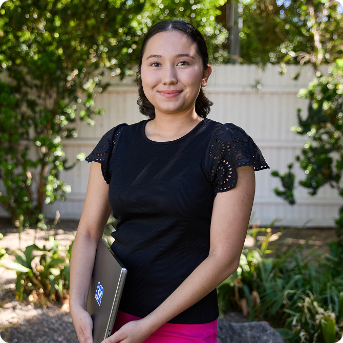 Student holding her laptop
